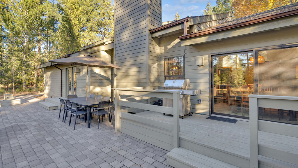 Back of the house among ponderosa pines with patio and hot tub